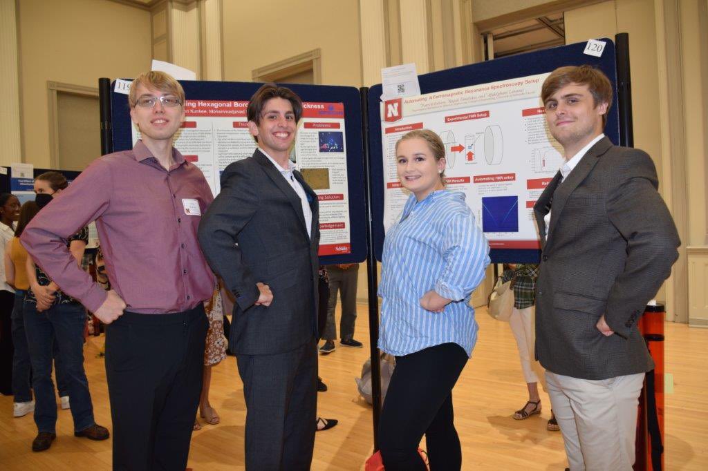 The four summer 2022 REU's strike a pose at the end of the summer poster session.