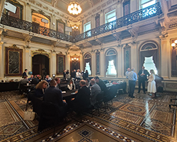 Wide shot of attendees working together in the Eisenhower building on the White House grounds.