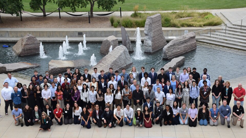 Convocation attendees gather for a group photo in front of the fountains outside the City Campus Union. 